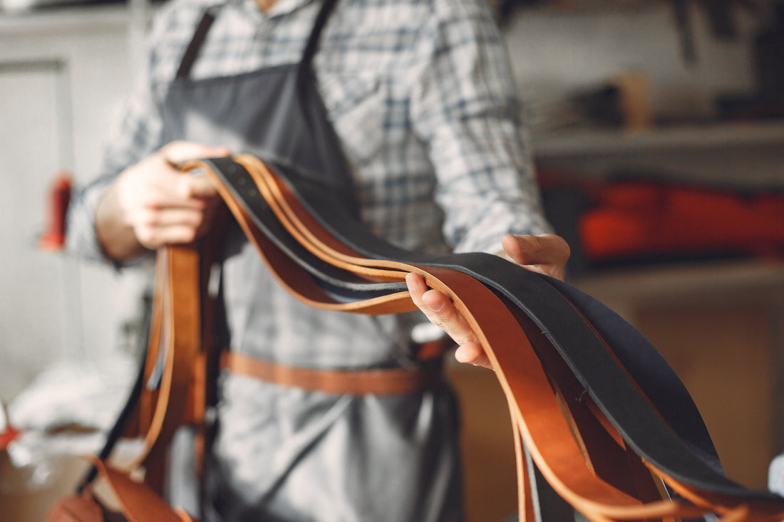 Man in a studio creates leather ware